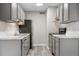 Modern kitchen featuring gray cabinets, stainless steel appliances, and sleek countertops at 10211 Ura Ln # 1-202, Thornton, CO 80260