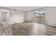 Neutral living room with modern flooring and access to a private patio, offering outdoor views and natural light at 10211 Ura Ln # 1-202, Thornton, CO 80260