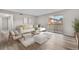 Bright living room with dining area features neutral colors and modern decor, with a view to a patio and exterior at 10211 Ura Ln # 1-202, Thornton, CO 80260