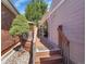 Wooden back deck with stairs leading to a manicured yard and access to house at 5231 S Cody St, Littleton, CO 80123