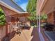Inviting backyard deck with outdoor seating, an umbrella, and a view of the landscaped outdoor space at 5231 S Cody St, Littleton, CO 80123
