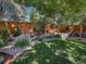 A serene backyard garden with lush greenery, trees, and stone accents, perfect for relaxation at 5231 S Cody St, Littleton, CO 80123