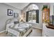 Bedroom featuring a large arched window and a neutral color scheme at 5231 S Cody St, Littleton, CO 80123