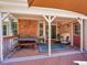 Relaxing covered deck featuring a table, bench, seating, and space for grilling, complemented by an outdoor rug at 5231 S Cody St, Littleton, CO 80123