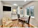 Dining area with seating for two, complemented by a bar area and a window with a view of the outside mountains at 5231 S Cody St, Littleton, CO 80123