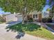 Charming home features a two-car garage and a well-maintained front lawn and landscape, complete with a tree at 5231 S Cody St, Littleton, CO 80123