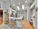 Bright kitchen with granite counters, island seating, skylights, and hardwood floors at 5231 S Cody St, Littleton, CO 80123
