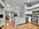 The kitchen features stainless steel appliances, white cabinets, and an open layout, perfect for entertaining at 5231 S Cody St, Littleton, CO 80123
