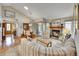 Cozy living room with a brick fireplace, wood floors, and lots of natural light at 5231 S Cody St, Littleton, CO 80123