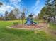 Community playground with slide, climbing structure, and benches surrounded by lush green grass at 5231 S Cody St, Littleton, CO 80123