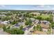 Aerial view showing a neighborhood with various homes, landscaping, and a park at 3908 Mariposa St, Denver, CO 80211