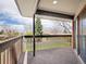 Wood balcony overlooks yard with mature trees at 2615 Oak Dr # 5, Lakewood, CO 80215