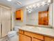 Well-lit bathroom with a wooden vanity, ample lighting, and a glass-enclosed shower at 2615 Oak Dr # 5, Lakewood, CO 80215