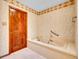 Tiled bathroom with a large tub and decorative border at 2615 Oak Dr # 5, Lakewood, CO 80215