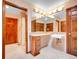 Tiled bathroom with double vanity, lots of lights, and a door to the shower/toilet room at 2615 Oak Dr # 5, Lakewood, CO 80215