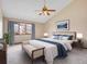 Vaulted ceiling bedroom featuring a ceiling fan, large window, and tastefully coordinated decor at 2615 Oak Dr # 5, Lakewood, CO 80215