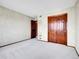 Bedroom with carpet, closet, and a door to another room at 2615 Oak Dr # 5, Lakewood, CO 80215