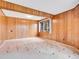Bedroom with wood paneled walls, neutral carpet and features a window for natural light at 2615 Oak Dr # 5, Lakewood, CO 80215