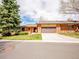 Charming single-story brick home with a two-car garage and well-maintained front lawn and mature trees at 2615 Oak Dr # 5, Lakewood, CO 80215