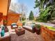 Paver brick patio with outdoor seating area featuring plush sofa and armchairs, and lovely landscaped backyard at 2615 Oak Dr # 5, Lakewood, CO 80215