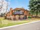 Two-story brick home with upper level covered porch and well-maintained landscaping at 2615 Oak Dr # 5, Lakewood, CO 80215