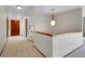 Open hallway features tile and carpet flooring and a decorative light fixture at 2615 Oak Dr # 5, Lakewood, CO 80215