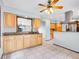 Open kitchen featuring light wood cabinetry, tile flooring, granite countertops, and stainless steel appliances at 2615 Oak Dr # 5, Lakewood, CO 80215