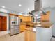 Kitchen with stainless steel appliances, light wood cabinets, stone countertops, and a tile backsplash at 2615 Oak Dr # 5, Lakewood, CO 80215