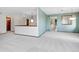 Open-concept living room featuring neutral decor, plush carpet and a decorative light fixture at 2615 Oak Dr # 5, Lakewood, CO 80215