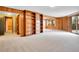 Bright living area boasts built-in shelving, wood walls, and transitions to a tiled area with a window at 2615 Oak Dr # 5, Lakewood, CO 80215