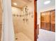 Updated shower with multiple shower heads, tiled walls, and a glass door at 2615 Oak Dr # 5, Lakewood, CO 80215