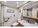 Neutral bathroom features a modern sink and vanity, a large mirror, and a glass door shower at 6504 Ralston Rd # A, Arvada, CO 80002
