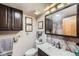 Bathroom features a white vanity, dark cabinets, and decorative nautical artwork at 6504 Ralston Rd # A, Arvada, CO 80002