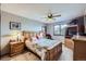 Comfortable bedroom with a ceiling fan, carpet flooring, and a large wooden bed frame at 6504 Ralston Rd # A, Arvada, CO 80002