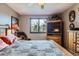 Comfortable bedroom features a wooden bed frame, a soft light, and a large window at 6504 Ralston Rd # A, Arvada, CO 80002