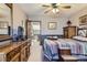 Well-lit bedroom with striped comforter, wood furniture, and an open doorway at 6504 Ralston Rd # A, Arvada, CO 80002