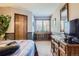 Bedroom featuring built-in display, wood trim, and plenty of light at 6504 Ralston Rd # A, Arvada, CO 80002