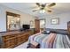 Comfortable bedroom with a striped comforter, wood dresser, and neutral wall colors at 6504 Ralston Rd # A, Arvada, CO 80002