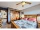 Bright bedroom features a large closet, a window, and neutral paint, plus a wooden bed frame at 6504 Ralston Rd # A, Arvada, CO 80002