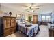 Bedroom features a multi-colored bedspread and a window, plus neutral-toned walls and carpet at 6504 Ralston Rd # A, Arvada, CO 80002