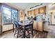 Sunny dining area with a window, wood floors and adjacent kitchen with lots of counter space at 6504 Ralston Rd # A, Arvada, CO 80002