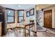 Sunlit dining area features wood floors, a wooden table and chairs, and access to a staircase at 6504 Ralston Rd # A, Arvada, CO 80002