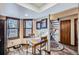 Charming dining area features wood floors, bright windows, and is adjacent to the home's staircase at 6504 Ralston Rd # A, Arvada, CO 80002