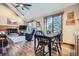 Bright dining area features wood floors, a large window and seating for four, creating a cozy atmosphere at 6504 Ralston Rd # A, Arvada, CO 80002