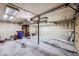 Clean garage featuring blue recycle cans, storage bins, and shelving units for storing tools and equipment at 6504 Ralston Rd # A, Arvada, CO 80002