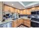 Bright kitchen features wooden cabinets, stainless steel appliances, and a stylish countertop at 6504 Ralston Rd # A, Arvada, CO 80002