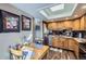 Well-lit kitchen with wood cabinets, stainless appliances, and a charming dining table at 6504 Ralston Rd # A, Arvada, CO 80002