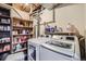 Functional laundry room with modern white washer and dryer, plus shelving for storage and supplies at 6504 Ralston Rd # A, Arvada, CO 80002