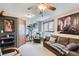 Comfortable room with natural lighting, featuring an accent wall, giraffe artwork, and cozy seating at 6504 Ralston Rd # A, Arvada, CO 80002