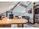 Office space with angled ceilings, a large desk, and comfortable seating at 6504 Ralston Rd # A, Arvada, CO 80002
